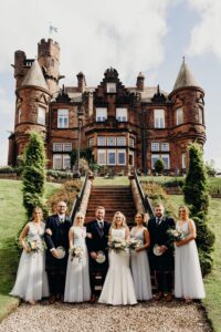 The bride and groom and the bridal party outside Sherbrooke Castle Glasgow wedding venue