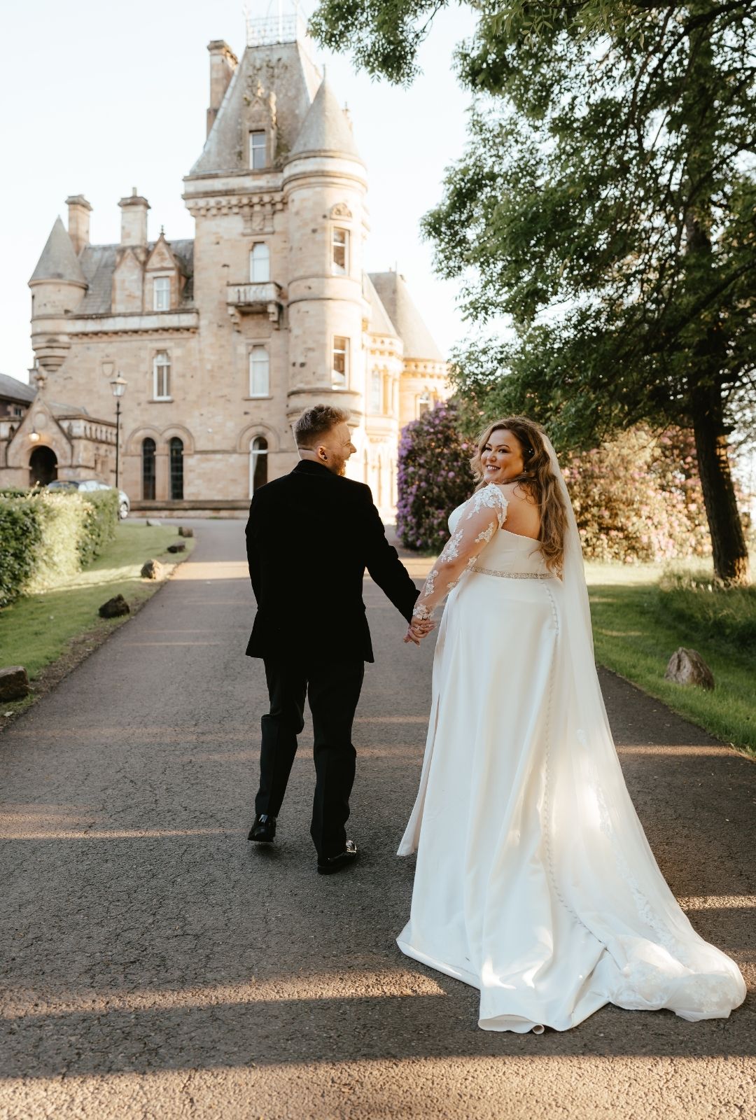 bride-sara-looks-back-in-front-of-cornhill-castle-wedding-venue